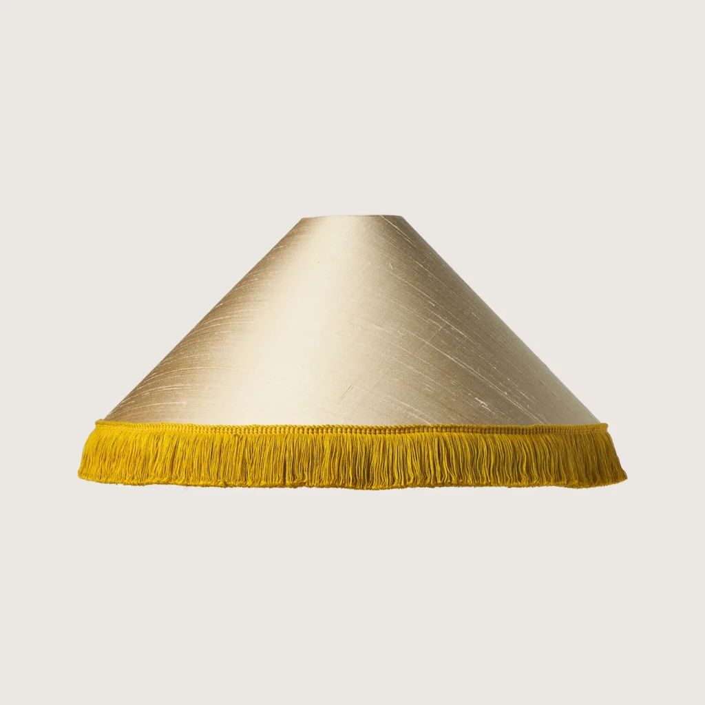 Beautifully formed conical lampshade, finished with a delicate yellow fringe along the bottom edge.