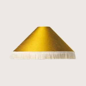 Fredzle.kolor5 A beautifully formed yellow conical lampshade, finished with a delicate white fringe along the bottom edge.