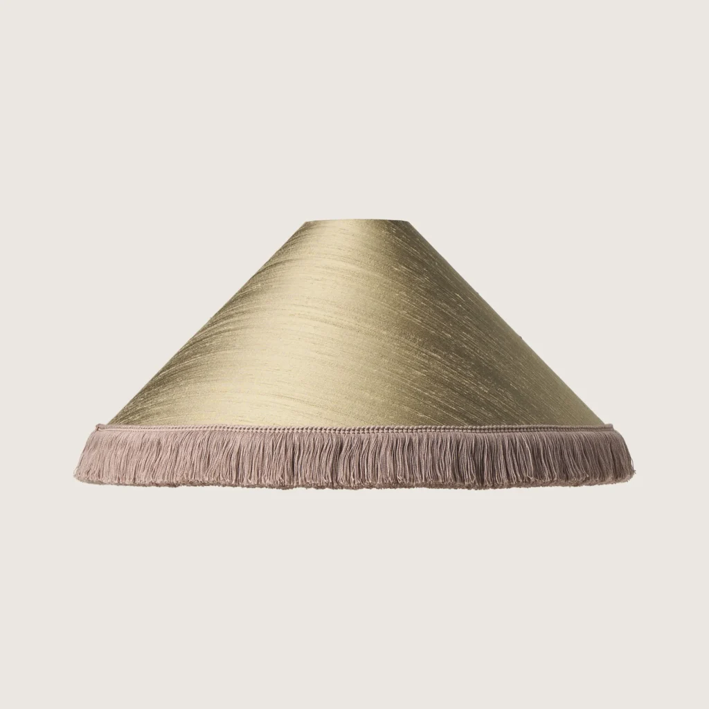 A beautifully formed grey conical lampshade, finished with a delicate grey fringe along the bottom edge.