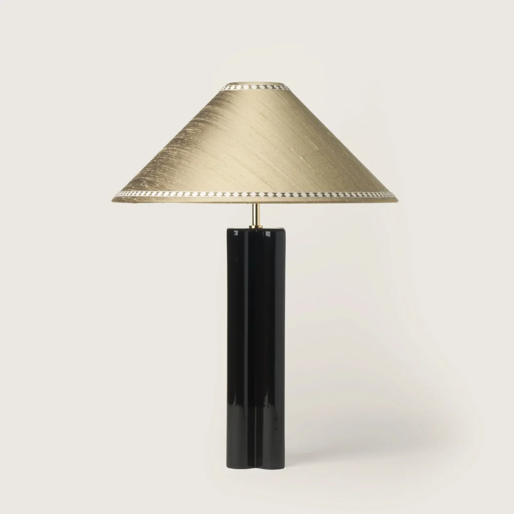 Elegant table lamp with a gray shade, ribbon, and a black base.