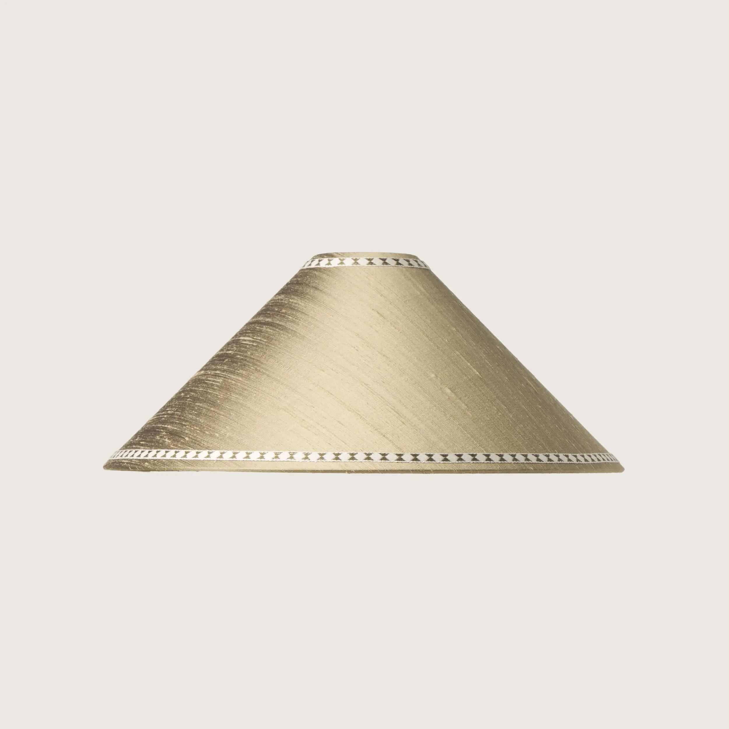 A beautifully formed gray conical lampshade, decorated with a delicate geometric pattern along the top and bottom edges.