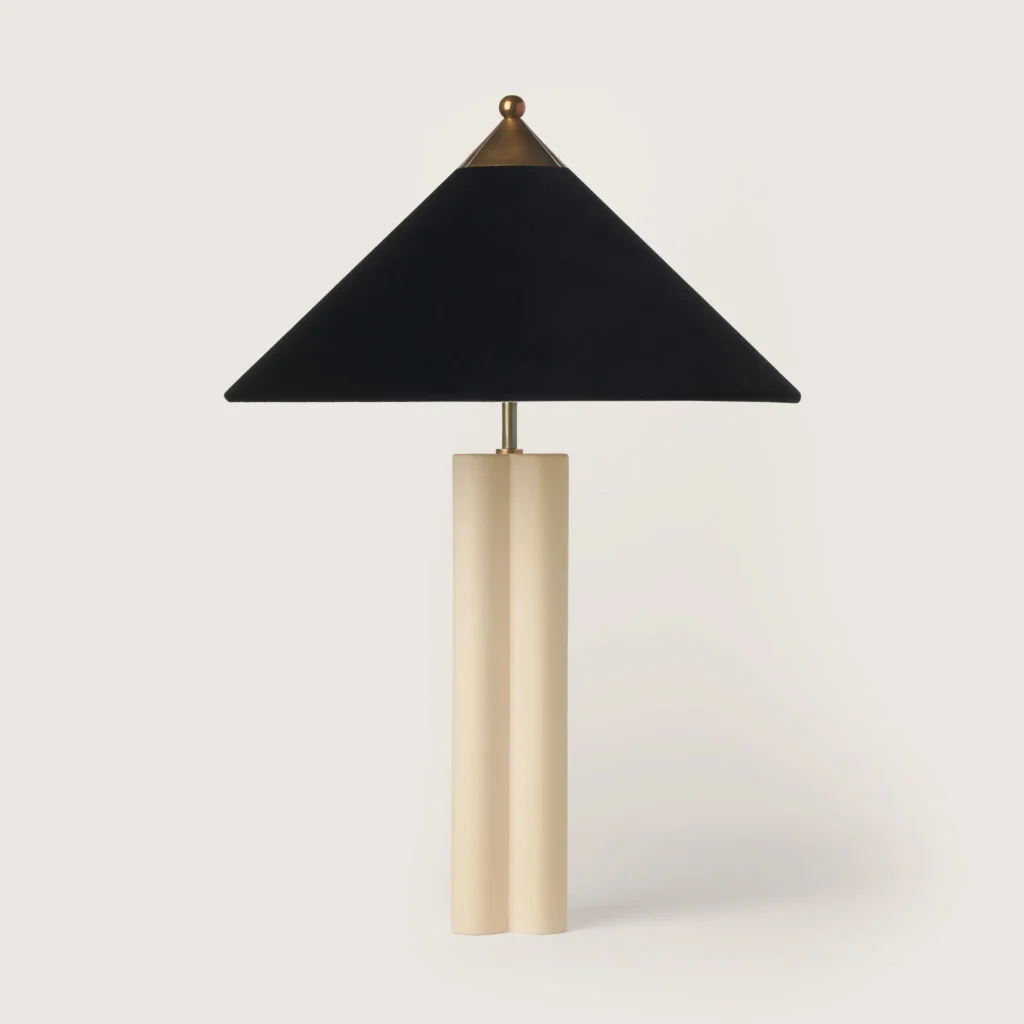 Elegant patinated table lamp with a grey velvet shade and cream base.