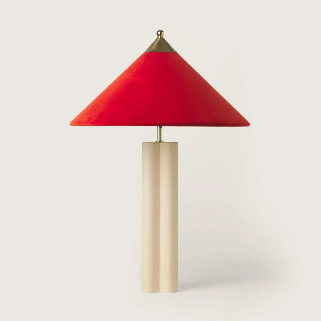 Elegant table lamp with a red velvet shade and cream base.
