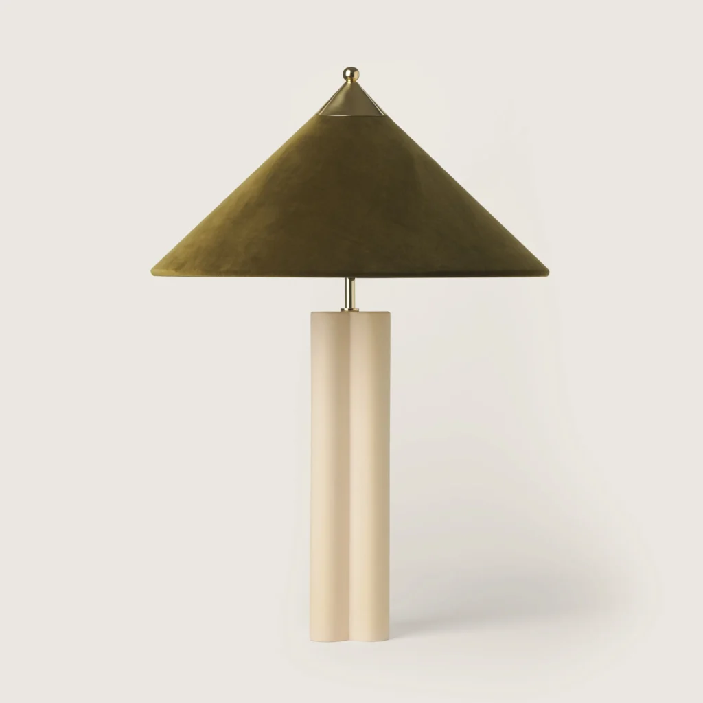 Elegant table lamp with olive velvet shade and cream base.