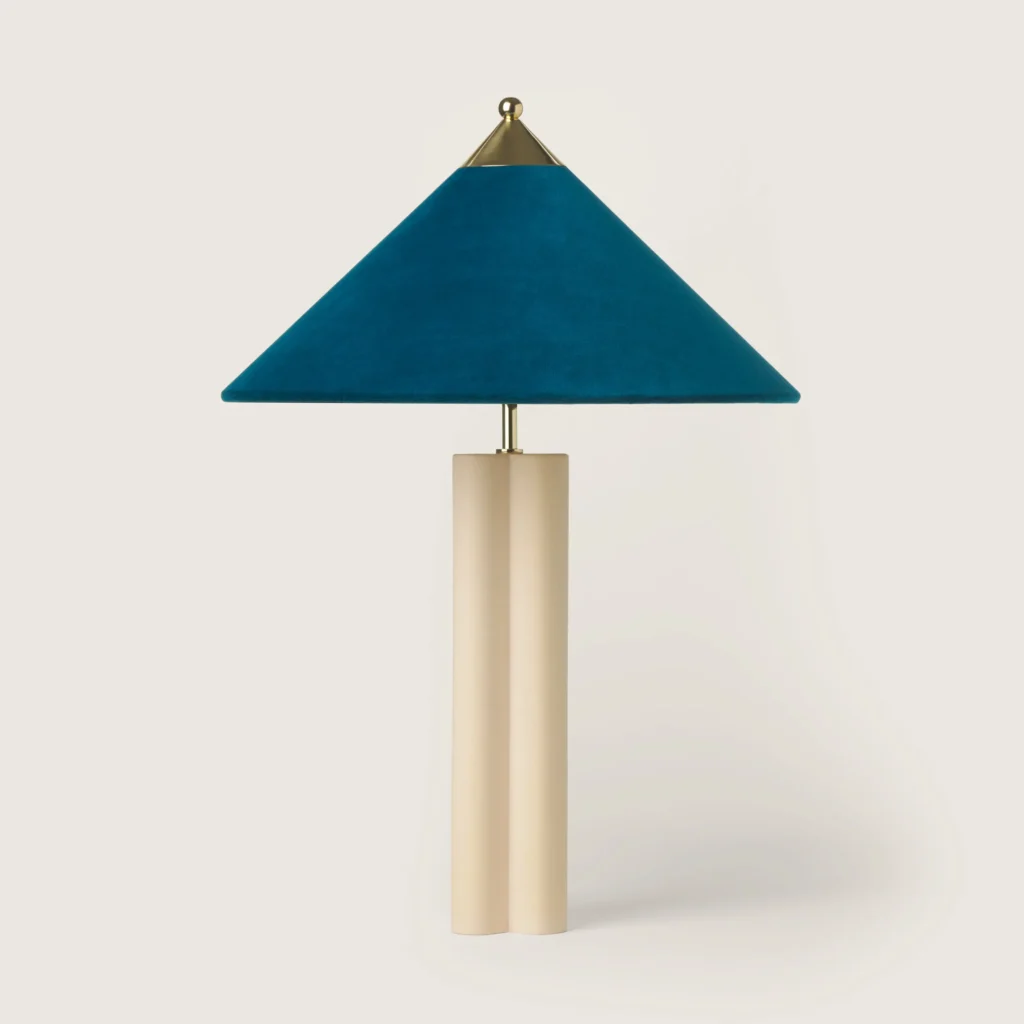 Elegant table lamp with a turquoise velvet shade and cream base.
